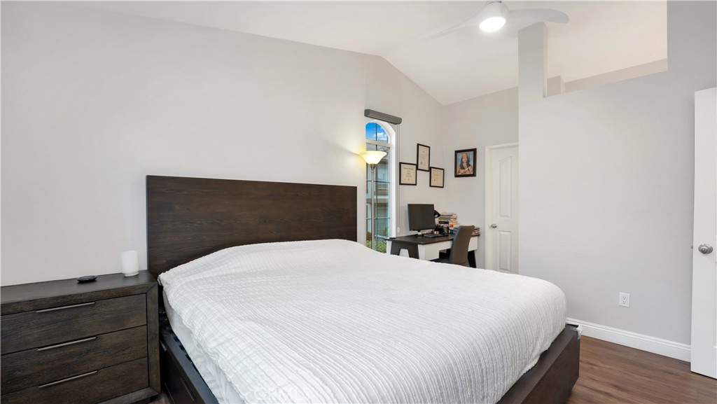 250 Chaumont Circle Lake Forest, CA 92610 - Photo 11 of 28 a bedroom with a bed and wooden floor