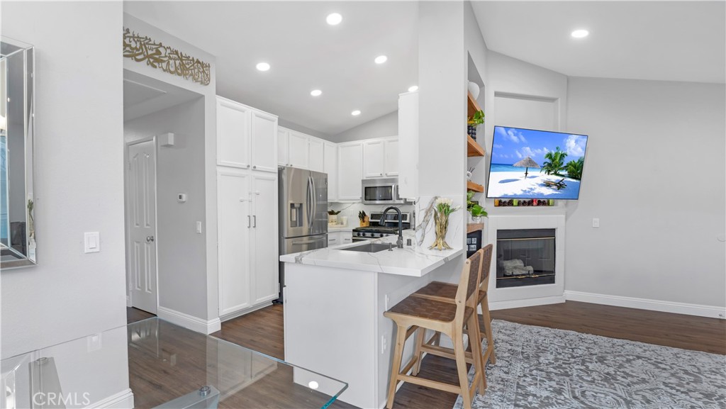 250 Chaumont Circle Lake Forest, CA 92610 - Photo 4 of 28 a kitchen with stainless steel appliances granite countertop a refrigerator and a stove top oven