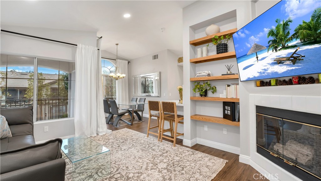 250 Chaumont Circle Lake Forest, CA 92610 - Photo 6 of 28 a living room with furniture a fireplace and a flat screen tv