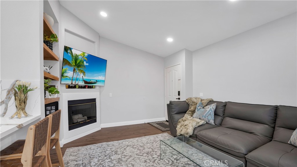 250 Chaumont Circle Lake Forest, CA 92610 - Photo 7 of 28 a living room with furniture a fireplace and a flat screen tv