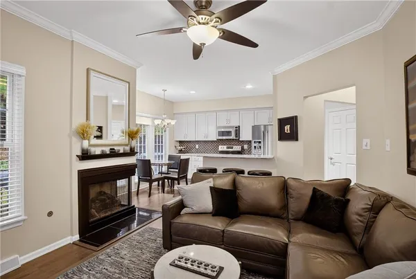 a living room with furniture kitchen and a fireplace