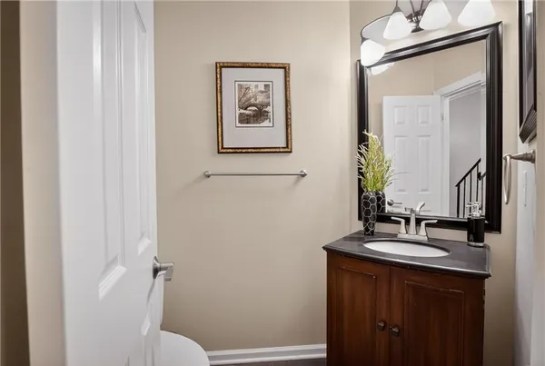 a bathroom with a sink and a mirror with toilet