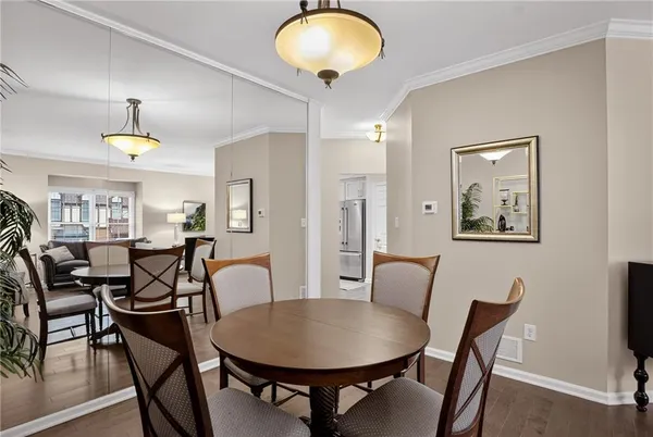 a view of a dining room with furniture and wooden floor