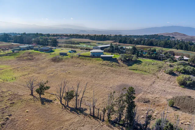 a view of a lake with an outdoor space and seating