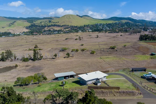 an aerial view of a house with a lake view