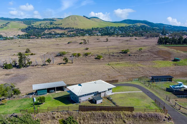 an aerial view of a house with outdoor space