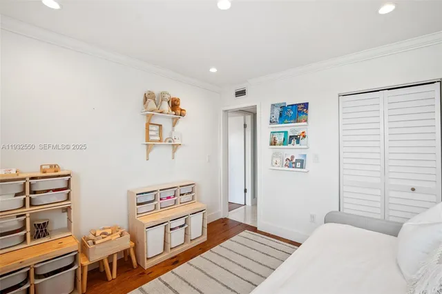 a bedroom with furniture and wooden floor