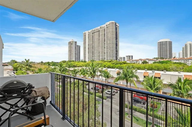 a view of a balcony with chair and wooden floor