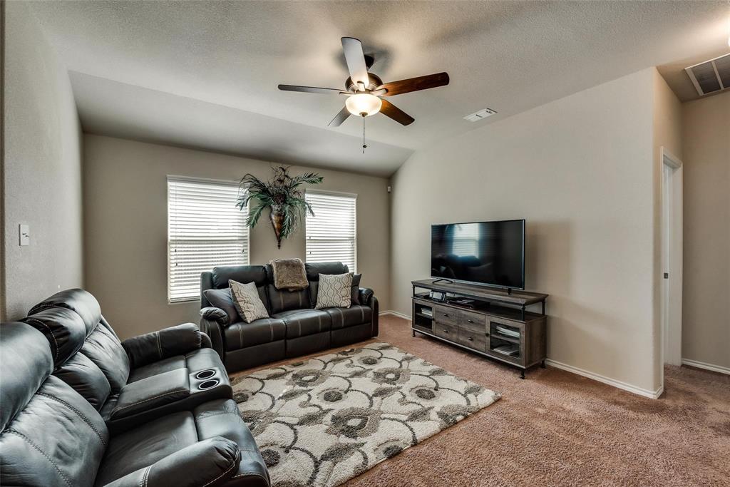 649 Clearbrook Street Azle, TX 76020 - Photo 12 of 28 a living room with furniture and a flat screen tv