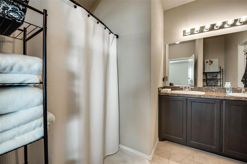 649 Clearbrook Street Azle, TX 76020 - Photo 16 of 28 a bathroom with a double vanity sink and mirror