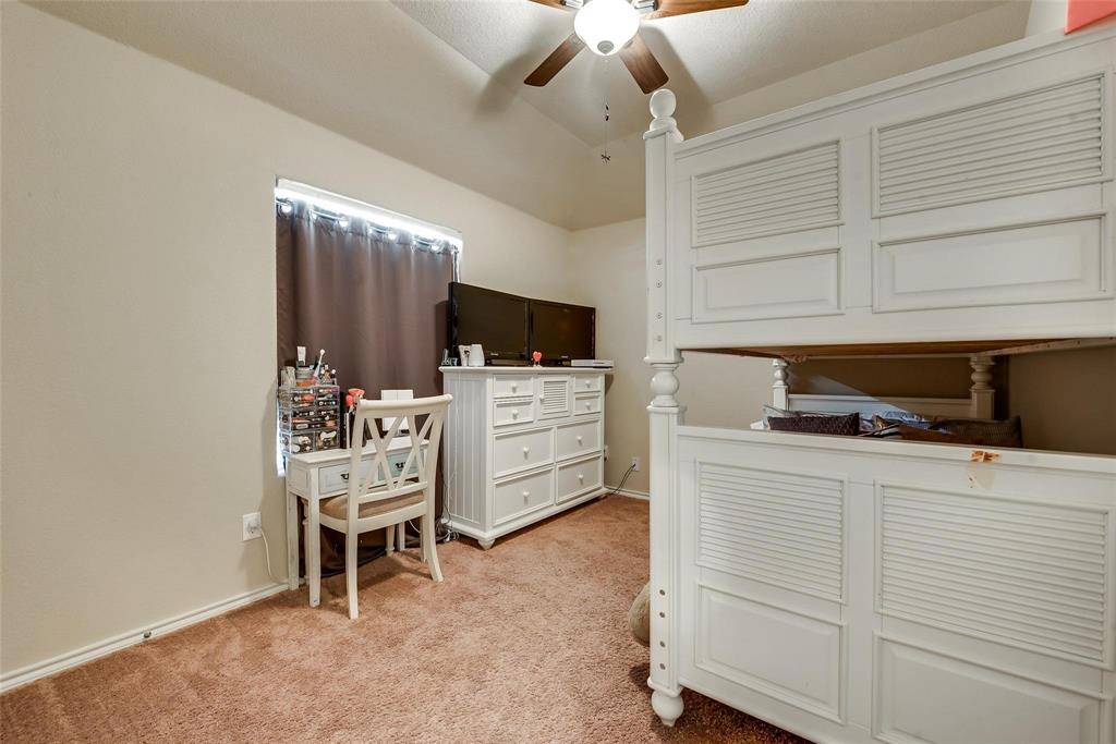 649 Clearbrook Street Azle, TX 76020 - Photo 19 of 28 a room with furniture a flat screen tv and white walls