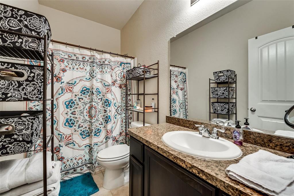 649 Clearbrook Street Azle, TX 76020 - Photo 20 of 28 a bathroom with a sink toilet and shower