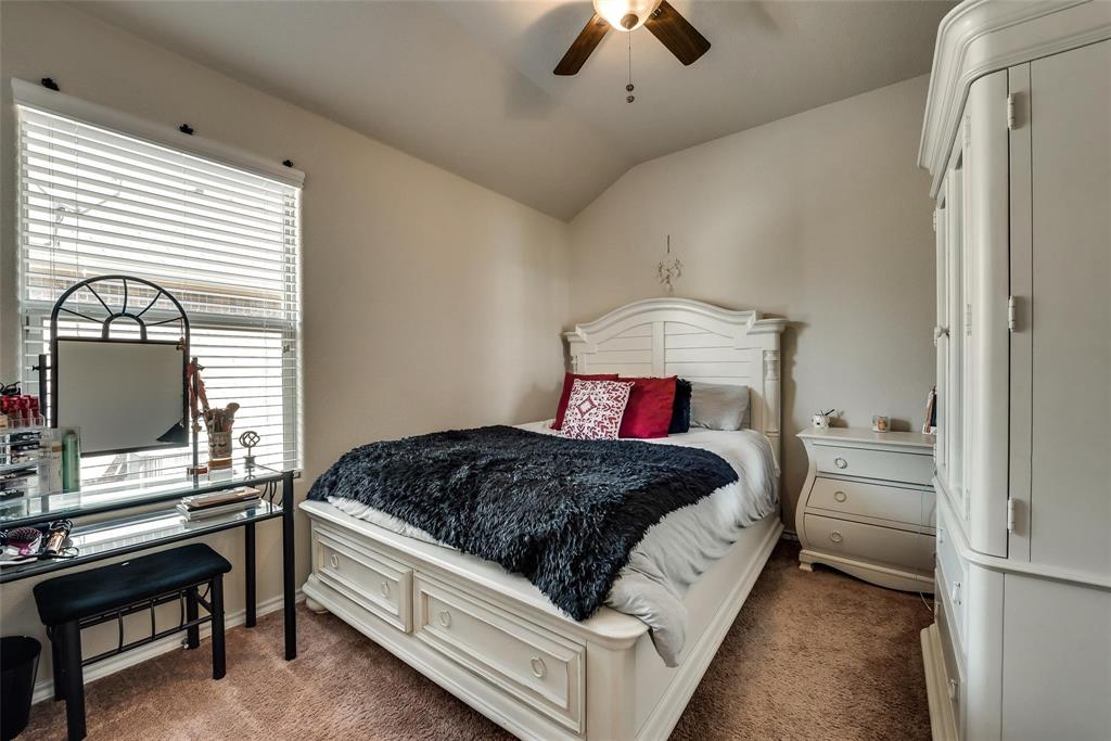 649 Clearbrook Street Azle, TX 76020 - Photo 22 of 28 a bedroom with a bed and a chandelier