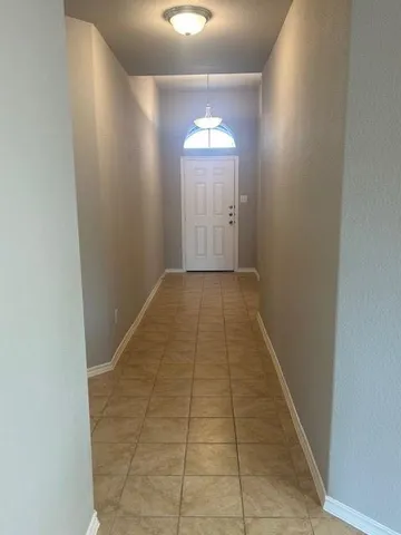 a kitchen with stainless steel appliances kitchen island granite countertop dining table chairs cabinets and a sink