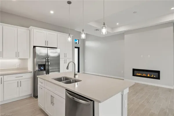 a kitchen with a sink a counter space and stainless steel appliances