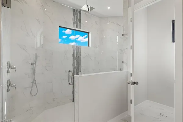 a bathroom with a shower and a mirror