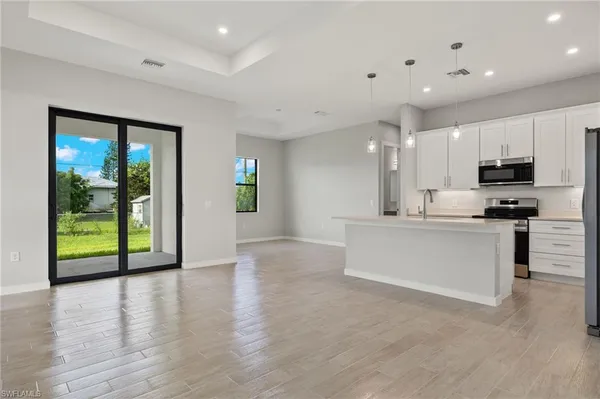 a view of kitchen with stainless steel appliances refrigerator oven and microwave