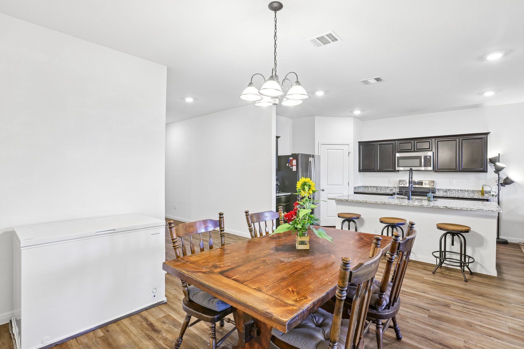19105 Mike Mansfield Road Manor, TX 78653 - Photo 9 of 28 a view of a dining room with furniture and wooden floor