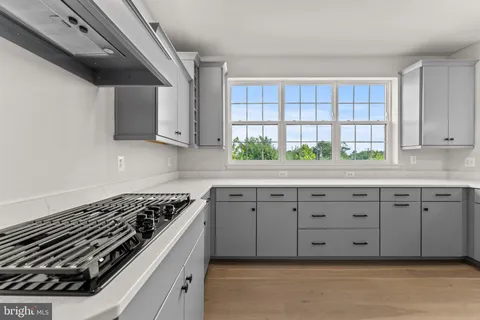 a kitchen with granite countertop a stove and a sink