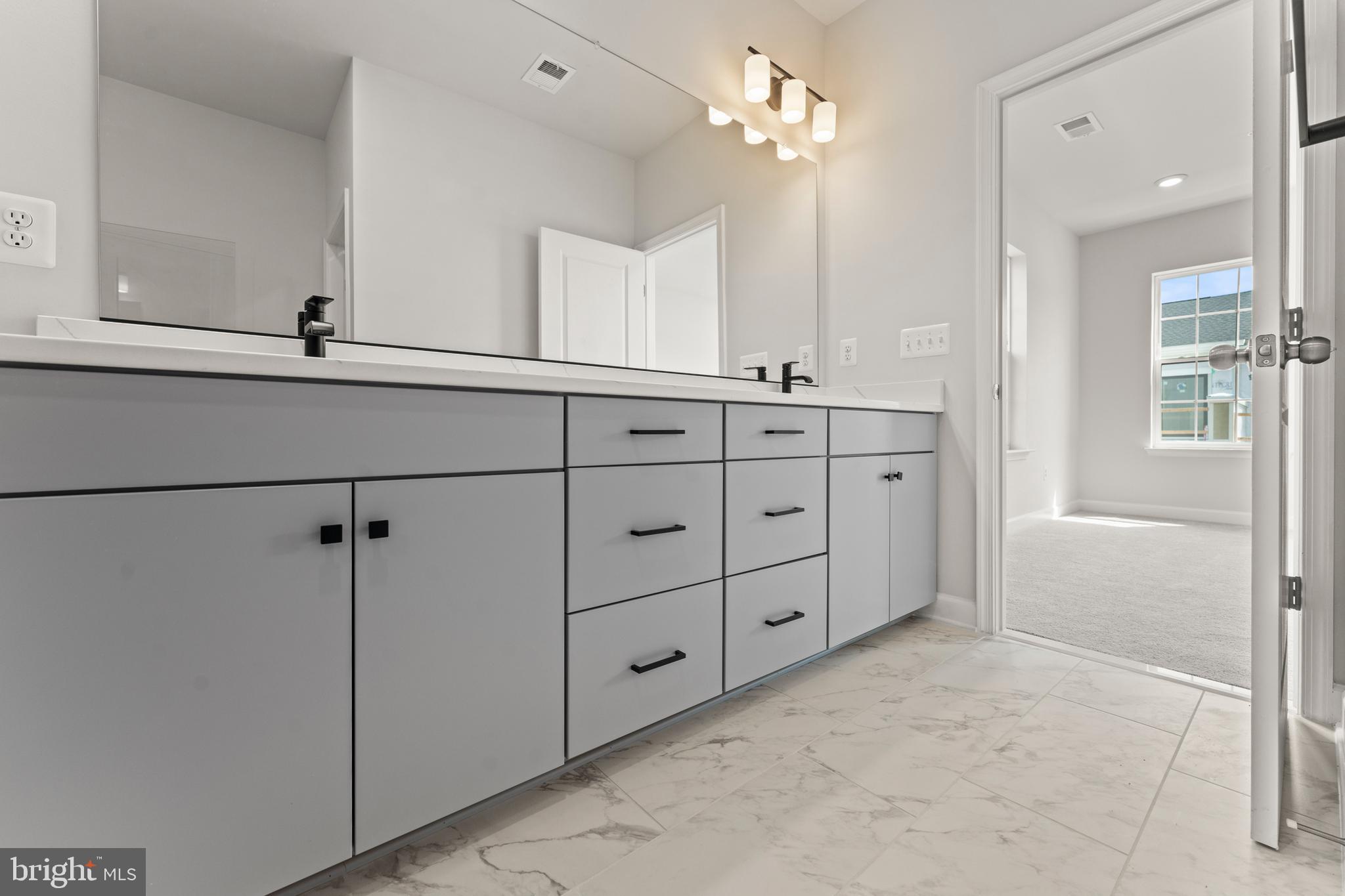 623 Trimaran Way Oxon Hill, MD 20745 - Photo 26 of 45 a bathroom with a double vanity sink a mirror and a shower