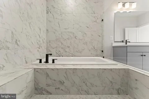 a spacious bathroom with a bathtub sink and toilet