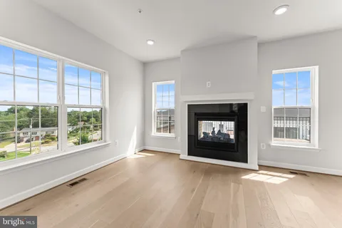 a view of an empty room with a fireplace and a window