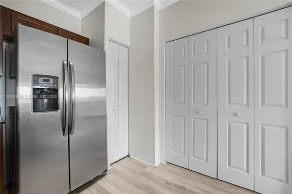 a kitchen with stainless steel appliances granite countertop a refrigerator microwave and sink