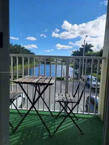 a view of a chairs and table in patio