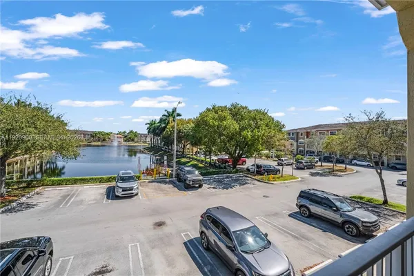 a view of a white house with a yard