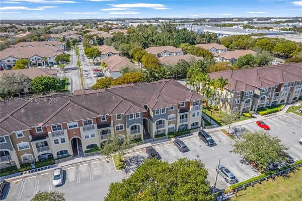 an aerial view of a house with garden space and street view