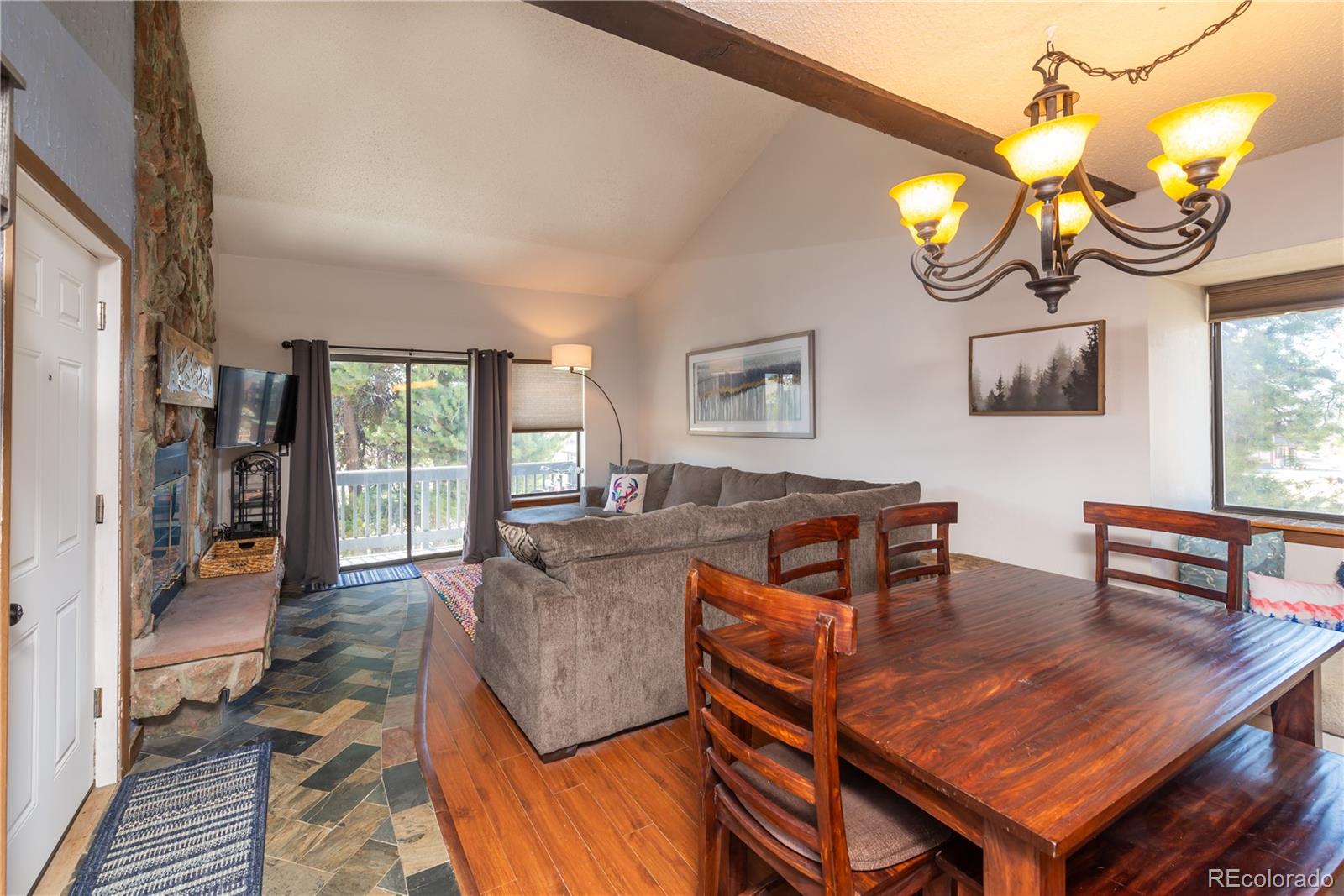 317 County Road 832, Unit 2412 Fraser, CO 80442 - Photo 2 of 17 a living room with furniture a rug and wall paintings