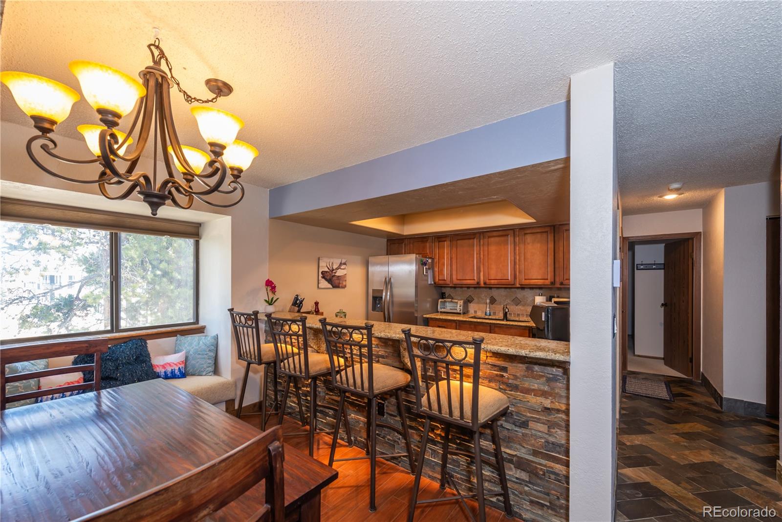 317 County Road 832, Unit 2412 Fraser, CO 80442 - Photo 3 of 17 a view of a dining room with furniture window and wooden floor