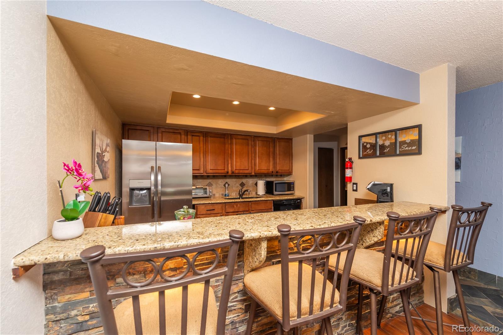 317 County Road 832, Unit 2412 Fraser, CO 80442 - Photo 6 of 17 a kitchen with stainless steel appliances kitchen island granite countertop a sink and cabinets