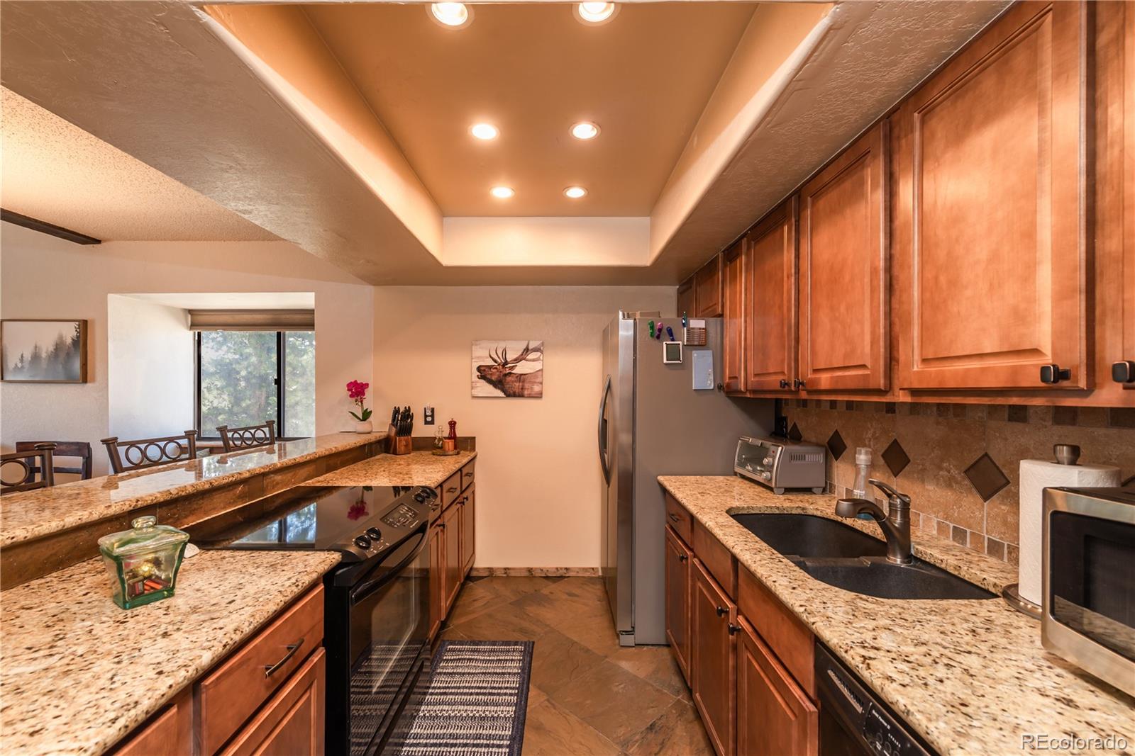 317 County Road 832, Unit 2412 Fraser, CO 80442 - Photo 7 of 17 a kitchen with stainless steel appliances granite countertop sink stove top oven and cabinets