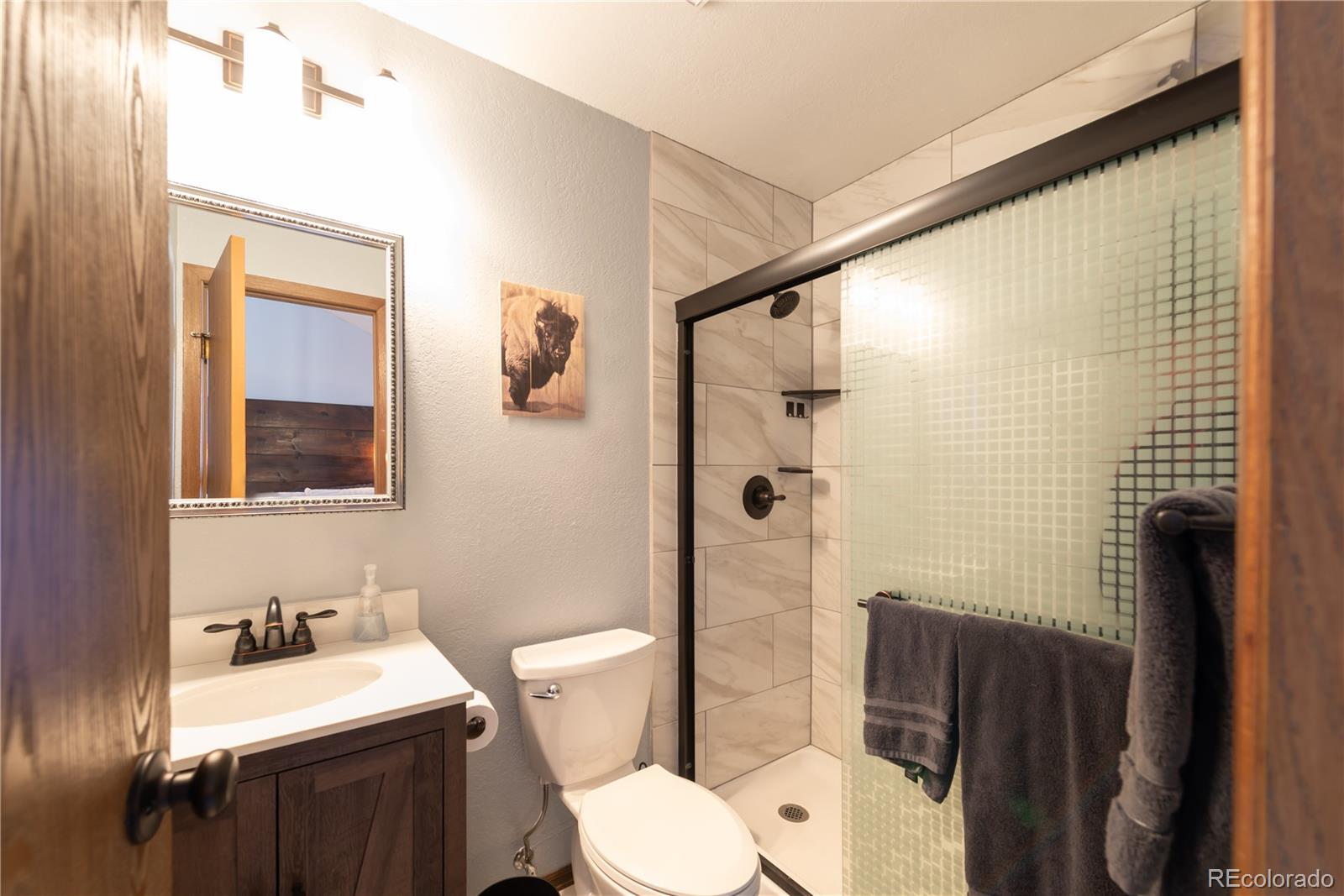 317 County Road 832, Unit 2412 Fraser, CO 80442 - Photo 10 of 17 a bathroom with a toilet a sink and shower