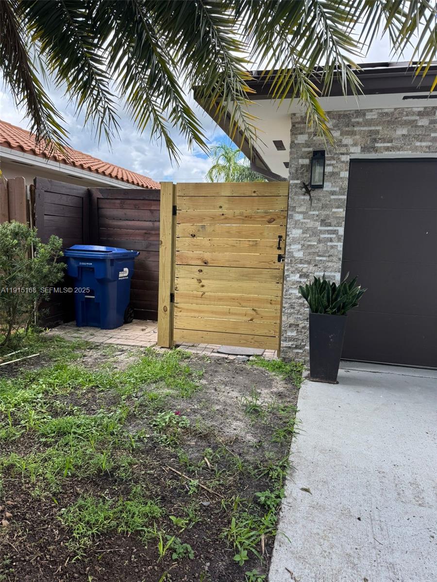 15620 Southwest 146th Avenue Miami, FL 33177 - Photo 2 of 9 a front view of a house with a garden