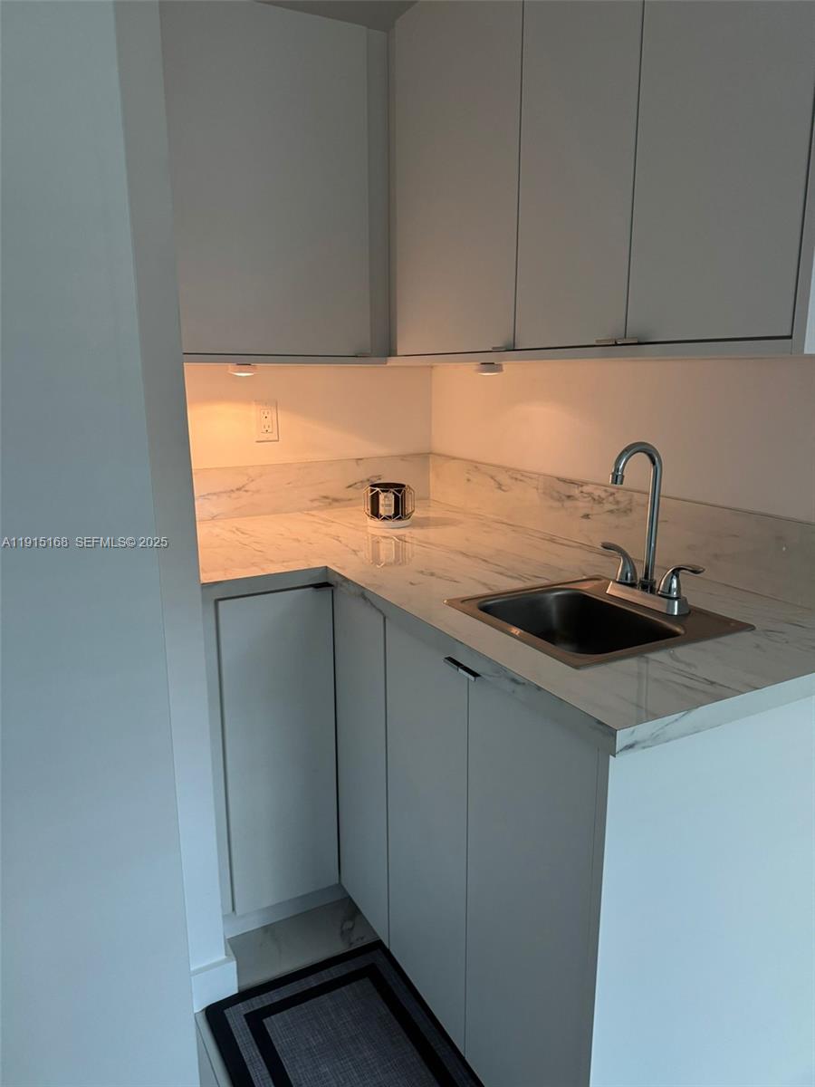 15620 Southwest 146th Avenue Miami, FL 33177 - Photo 4 of 9 a kitchen with a sink and cabinets