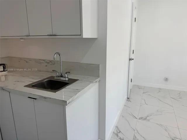 a kitchen with a sink and cabinets