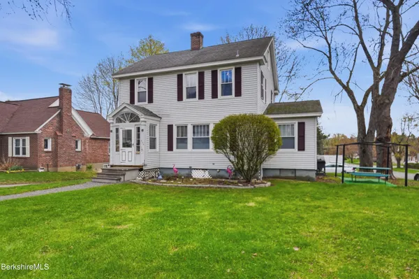 a front view of a house with a yard and porch