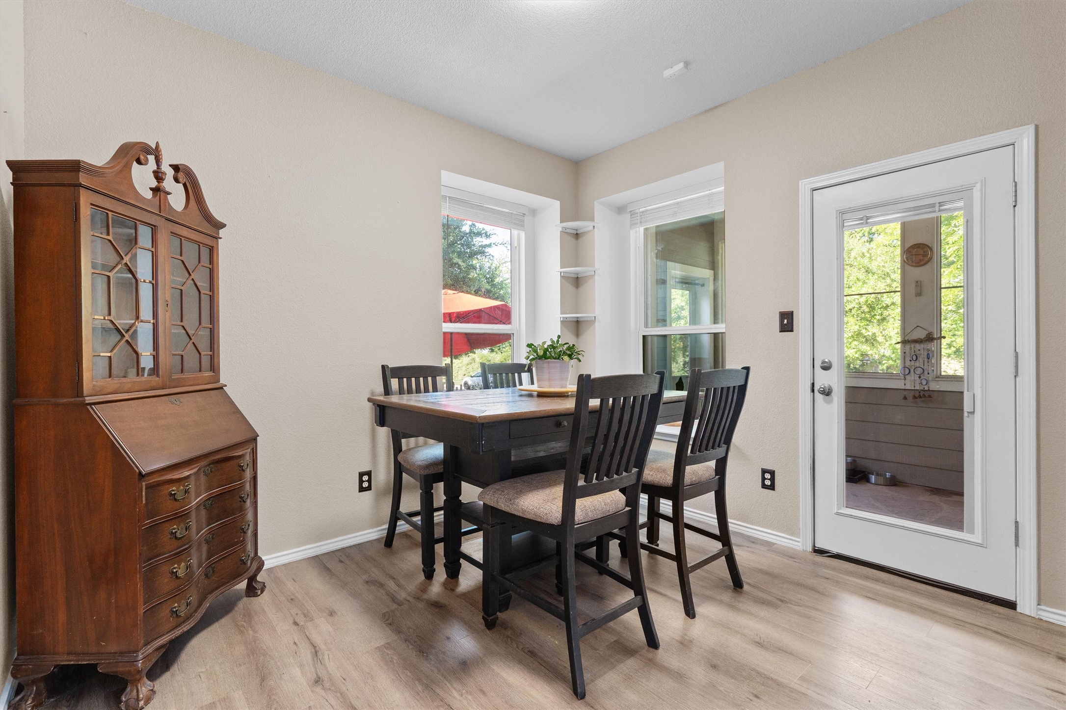 1833 Thompson Trail Round Rock, TX 78664 - Photo 13 of 40 A welcoming dining area with wood flooring and abundant natural light flows seamlessly to an outdoor space.