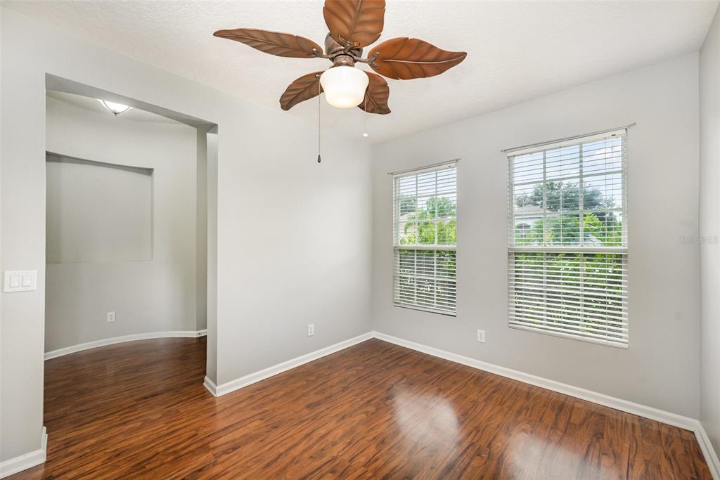 531 Cressa Circle Cocoa, FL 32926 - Photo 14 of 16 a view of an empty room with wooden floor and a window