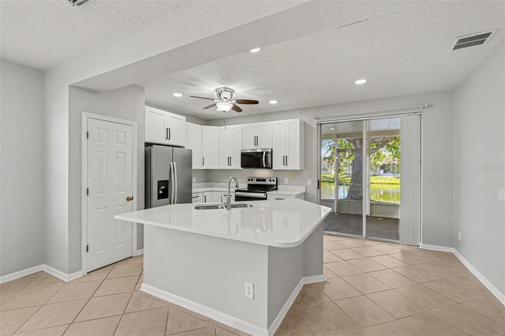 531 Cressa Circle Cocoa, FL 32926 - Photo 3 of 16 a large kitchen with stainless steel appliances a large counter top a stove a refrigerator and a sink