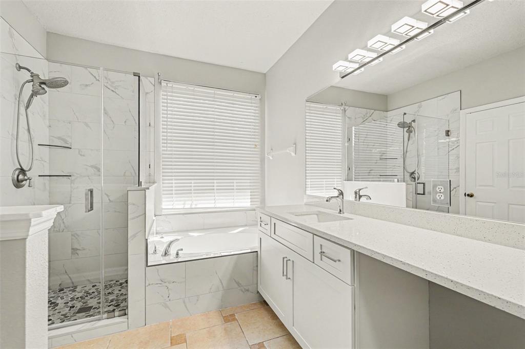 531 Cressa Circle Cocoa, FL 32926 - Photo 9 of 16 a bathroom with a sink double vanity granite tub shower and a mirror