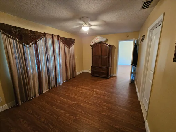 a view of a hallway with wooden floor and stairs