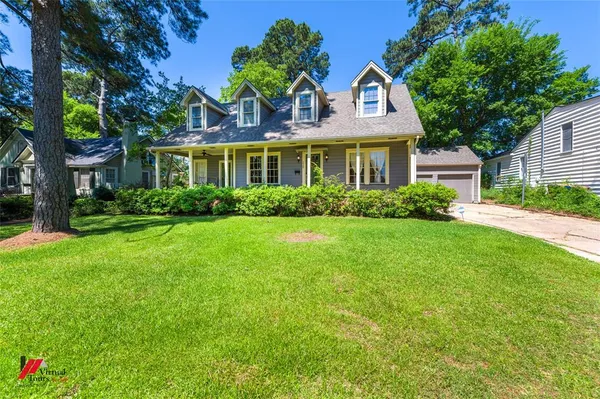 front view of a house next to a yard