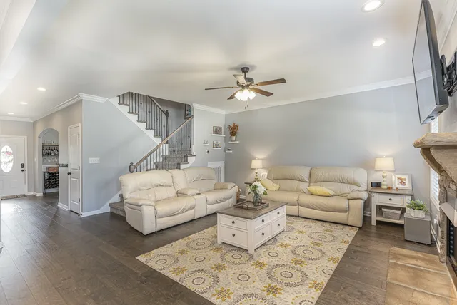 a living room with furniture and a chandelier