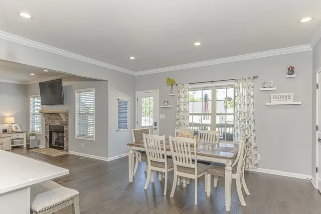 a dining room with furniture and a fireplace
