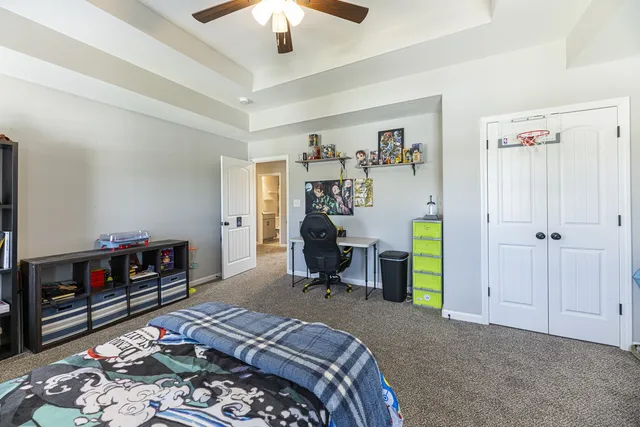 a bedroom with bed and a chandelier