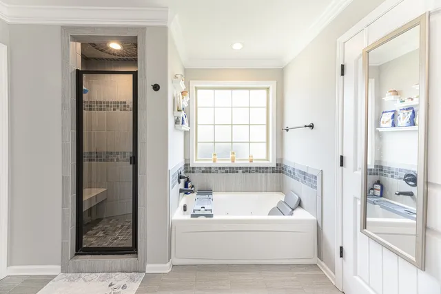 a white bath tub sitting next to a window