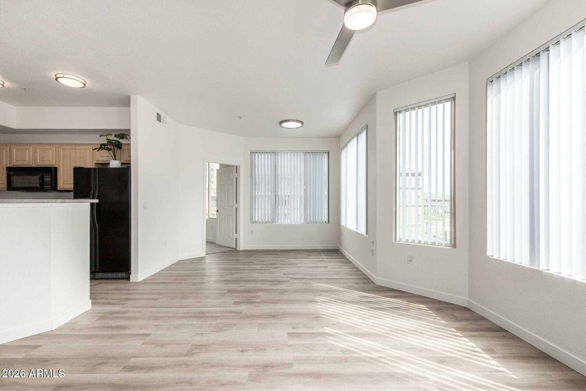 435 West Rio Salado Parkway, Unit 305 Tempe, AZ 85281 - Photo 19 of 44 a view of an empty room with a window and wooden floor